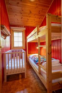 two bunk beds in a room with red walls at Nice Sirdal Bungalow in Ådneram in Ådneram