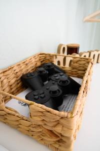 a basket with two video game controllers in it at Hygge Home at Trikala in Tríkala