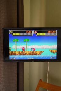 a television screen with a video game on it at Hygge Home at Trikala in Tríkala +25 photos
