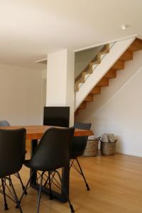 a table and chairs in a room with a staircase at "Chalet H28" mit 4 Schlafzimmer in Todtnau-Muggenbrunn in Muggenbrunn +26 photos