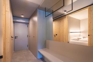 une chambre avec un miroir et un lit dans une pièce dans l'établissement Alpine Nest Bovec, à Bovec 13 autres photos