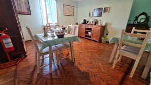 a dining room with a table and chairs in a room at Foresteria due Galli in San Martino del Lago +10 photos