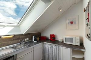 a kitchen with a sink and a skylight at Ferienwohnung Sämann in Oberkirch +17 photos