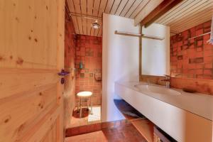 a bathroom with a sink and a counter with a stool at Vue mer et acces plage direct pour 11 personnes in Saint-Gildas-de-Rhuys +24 photos