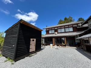 YamakamiにあるGuest House DETARAMESOの建物の隣にある小さな黒い家