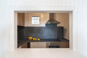 a kitchen with a sink and a stove top oven at Pierre & Vacances Ros Ibiza in Santa Eularia des Riu