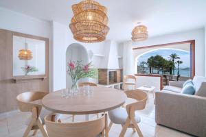 a living room with a table and a couch at Pierre & Vacances Ros Ibiza in Santa Eularia des Riu