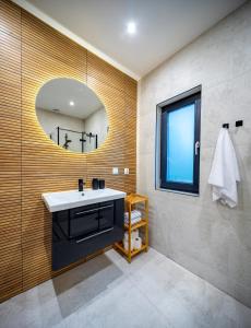 a bathroom with a sink and a mirror at Wilcza Stodoła 2 in Uście +24 photos