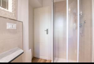 a shower with a glass door in a bathroom at Lucca City Center Apartment - AC WiFi in Lucca