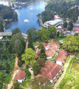 an aerial view of a house next to a river at The Tredis Heritage by the Lake in Kodaikānāl