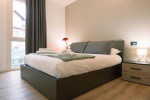 a bedroom with a large bed and a window at Costa blu - Pool and terrace overlooking the lake in Riva di Solto