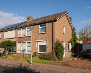 a brick house on the side of a street at Les Maisons Domburg in Domburg
