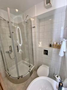 a bathroom with a shower and a toilet and a sink at City center Gold in Split