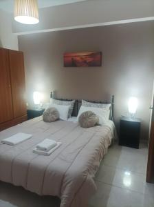 A bed or beds in a room at Eirini's Apartment