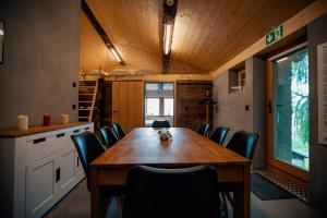 a dining room with a wooden table and chairs at Le Mayen de Colombire in Crans-Montana +24 photos