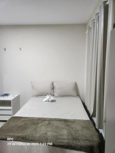 a bed in a white room with a window at Casa Nova Temporada Barreirinhas Lençóis Maranhense in Barreirinhas +8 photos
