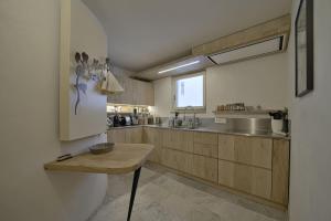 a kitchen with wooden cabinets and a wooden table at Chesa Ronchi - Celerina in Celerina
