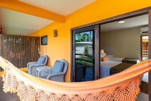 a hammock in a room with a bedroom at Pousada Canto do Sol in Barra Grande
