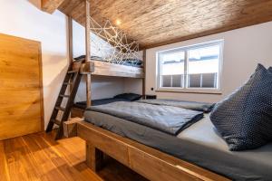 a bedroom with a bunk bed and a ladder at Appartement Hoamatgfüh in Saalbach-Hinterglemm