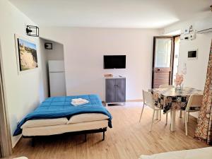 a bedroom with a bed and a dining room with a table at Nata Sicula in Syracuse