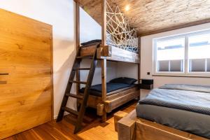 a bedroom with a bunk bed and a ladder to a bunk bed at Appartement Hoamatgfüh in Saalbach-Hinterglemm +27 photos