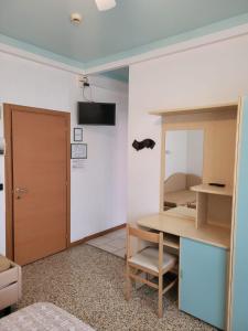 a room with a table and a mirror and a door at Hotel Residence Villa Lily in Cesenatico