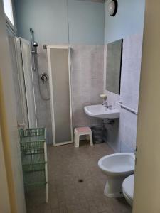 a bathroom with a toilet and a sink and a shower at Hotel Residence Villa Lily in Cesenatico +13 photos