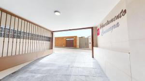 an empty hallway of a building with a sign on the wall at Apartamentos Consuegra frente a los molinos in Consuegra +131 photos