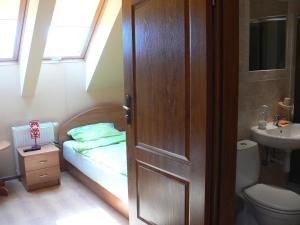 a small bathroom with a bed and a sink at Kalski Dworek in Węgorzewo +110 photos