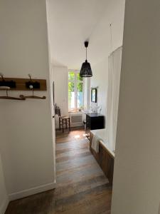 a hallway leading to a living room with a table at Cottage-Saint Laurent sur Sèvre in Saint-Laurent-sur-Sèvre