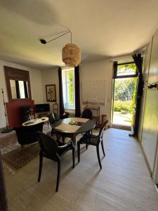 a living room with a dining table and chairs at Cottage-Saint Laurent sur Sèvre in Saint-Laurent-sur-Sèvre