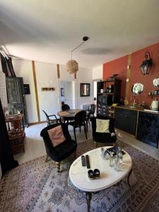 a living room with a table and chairs at Cottage-Saint Laurent sur Sèvre in Saint-Laurent-sur-Sèvre +13 photos
