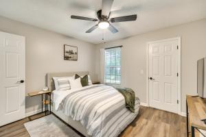 a bedroom with a bed and a ceiling fan at 2 Mi to Fort Stewart Modern Hinesville Haven in Hinesville