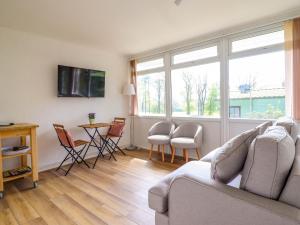 a living room with a couch and a table with chairs at Hill View in Tywyn