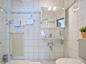 a bathroom with a sink and a shower at Landpension Am Sommerhang in Bad Rippoldsau +107 photos