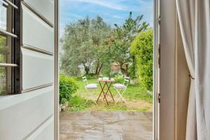 a door leading to a patio with a table and chairs at Cantagrillo Boutique Hotel in Vinci