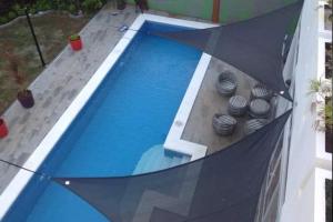 an umbrella in front of a swimming pool at Beautiful house in Boracay Aklan in Boracay