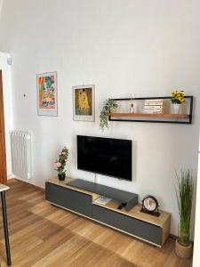 a living room with a flat screen tv on a wall at Kaléa Gallipoli in Gallipoli