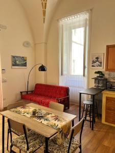 a living room with a red couch and a table at Kaléa Gallipoli in Gallipoli