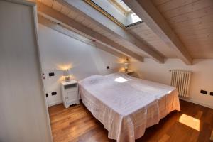 a bedroom with a bed and two night stands at Bello Pianello Lake View Apartment in Pianello Del Lario +27 photos