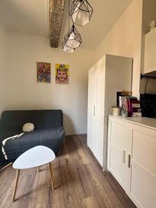 a living room with a black couch and a table at Stud'Arles in Arles