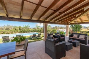 an outdoor patio with chairs and a pool at Villa Auba by Sealand Villas in El Port