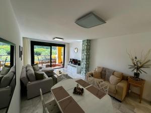 a living room with a couch and a table at Green Hill Apartment in La Cala de Mijas