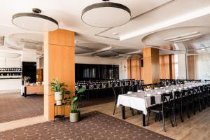 a banquet hall with tables and chairs in a room at Hotel Wodnik in Giżycko