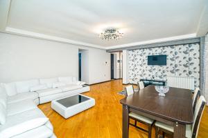 a living room with a white couch and a table at Pandora in Baku