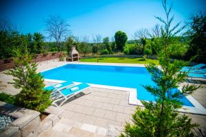 a swimming pool with two lounge chairs in a yard at Villa Tia in Mostar +60 photos