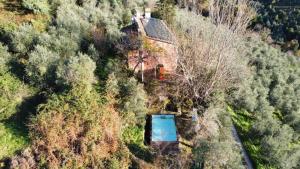 an aerial view of a house in the middle of a forest at Villa in Toscana con Piscina privata e parco privato in Montemagno