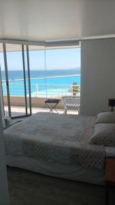 a bedroom with a bed and a view of the ocean at San Alfonso del Mar Goleta 307 in San Antonio