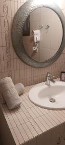 a bathroom with a sink and a mirror at Petrino 2 semibased by Vasileia in Sarti +12 photos