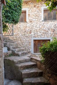 a stone building with stairs in front of it at Lazulino Suite by Klodge in Olbia